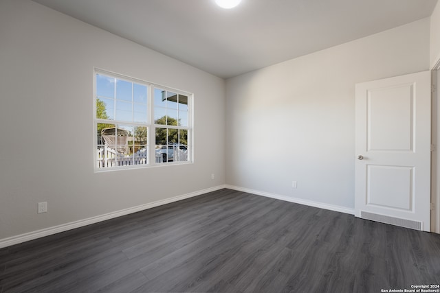 empty room featuring dark hardwood / wood-style flooring