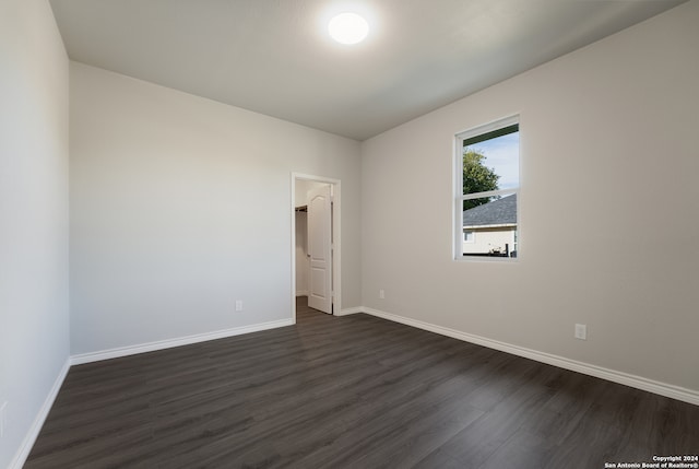 empty room with dark hardwood / wood-style flooring