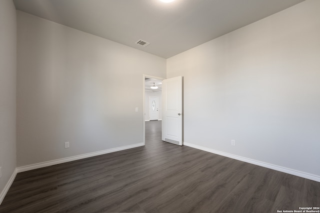 spare room with dark hardwood / wood-style flooring