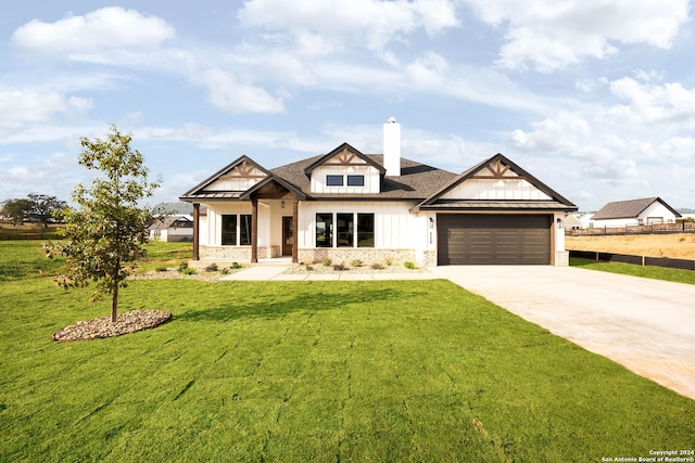 craftsman house with a garage and a front lawn