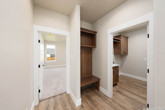 mudroom with light hardwood / wood-style floors