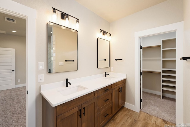 bathroom with vanity and hardwood / wood-style flooring