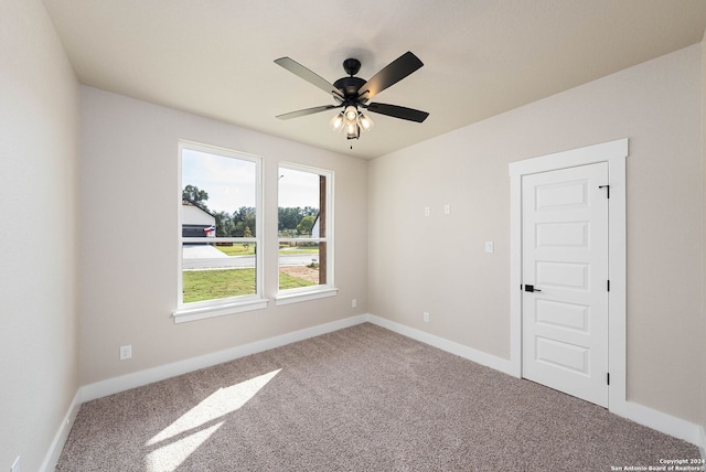 empty room featuring ceiling fan and carpet floors