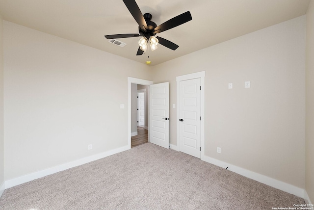 unfurnished bedroom featuring ceiling fan and carpet