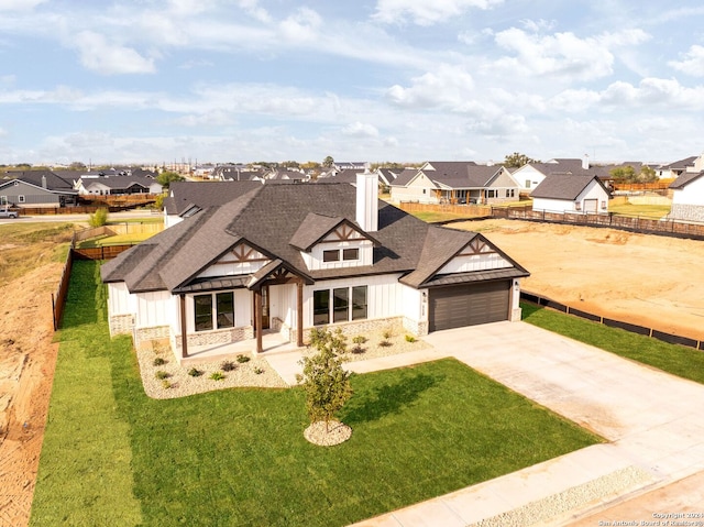 view of front of house with a garage and a front yard