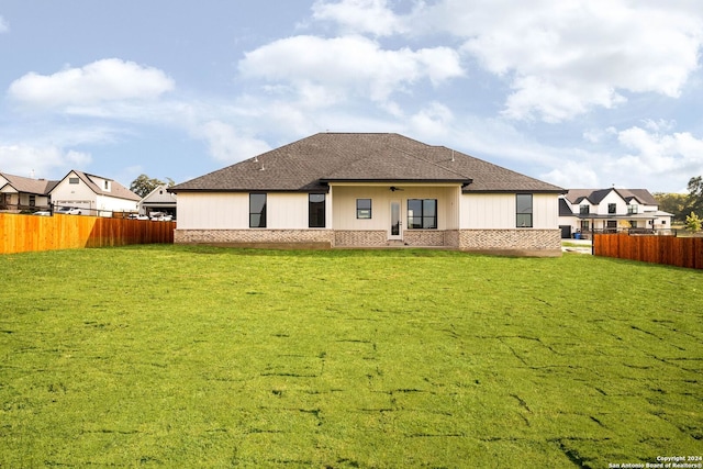 rear view of house with a yard