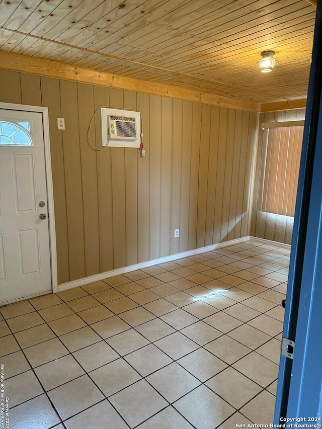 tiled entrance foyer featuring a wall mounted air conditioner and wooden ceiling