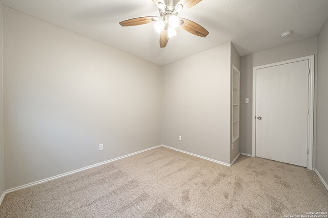 unfurnished room featuring ceiling fan and light colored carpet