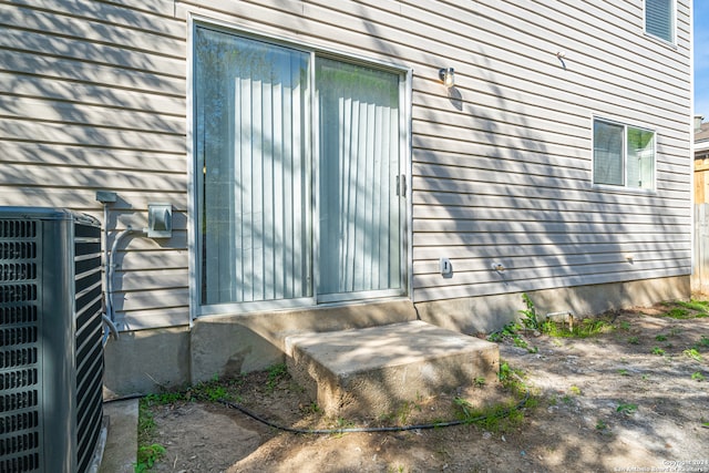 entrance to property featuring cooling unit