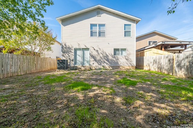 rear view of property with central AC unit