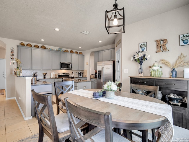 dining room with light tile patterned floors and a textured ceiling