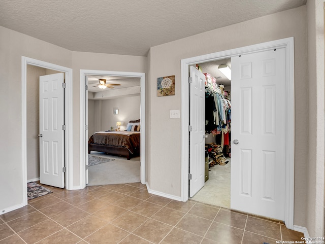 interior space with a textured ceiling and light colored carpet