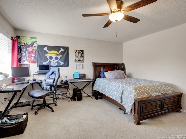 carpeted bedroom with ceiling fan and a textured ceiling