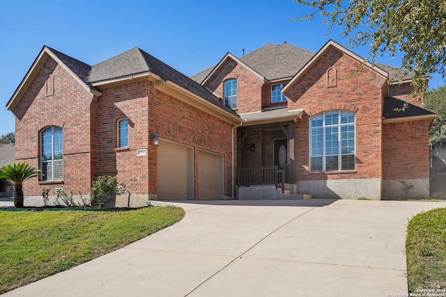 view of front of home featuring a garage and a front lawn