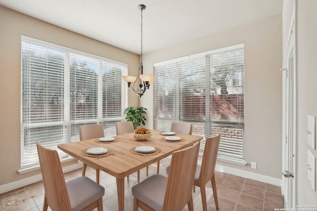 tiled dining space with a chandelier