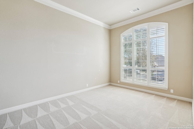 carpeted empty room with plenty of natural light and ornamental molding