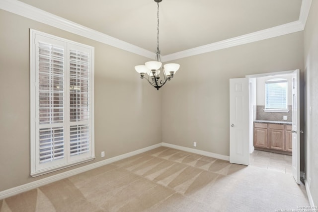 carpeted spare room with a chandelier and ornamental molding