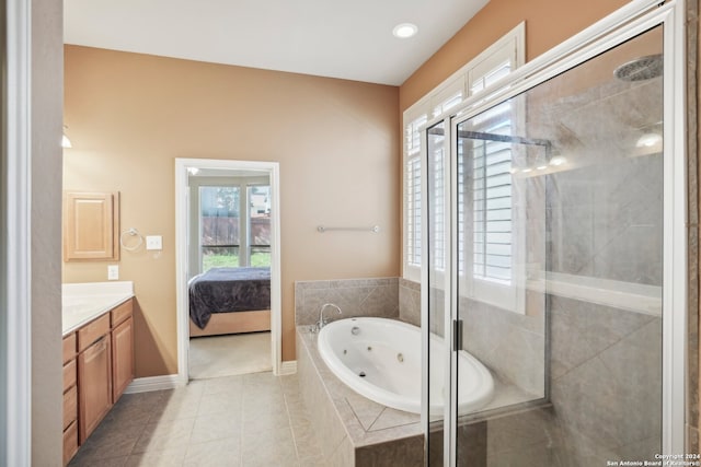 bathroom featuring separate shower and tub, tile patterned flooring, and vanity