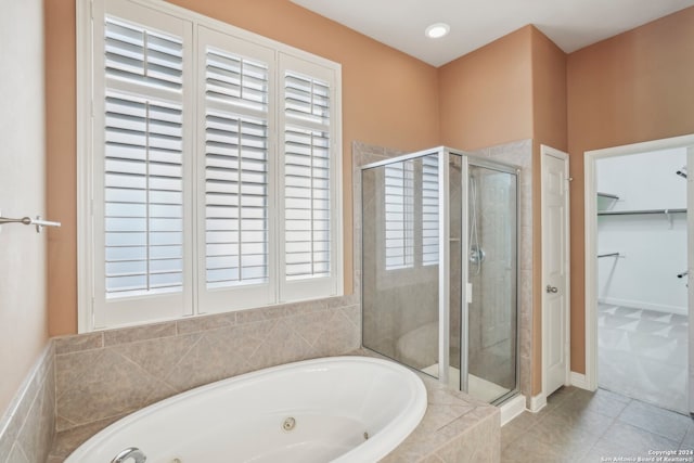 bathroom with separate shower and tub and tile patterned floors