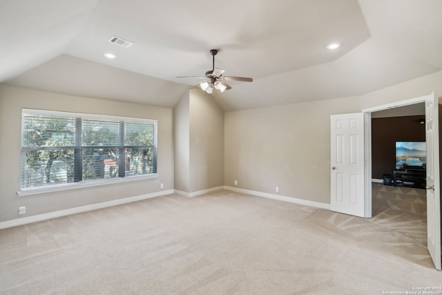 interior space with ceiling fan, lofted ceiling, and light carpet