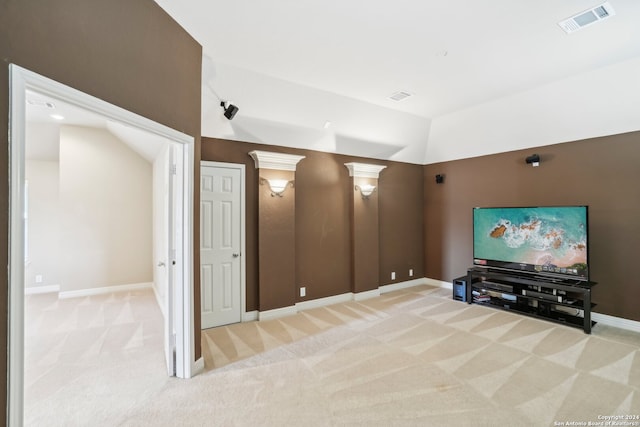 cinema with light colored carpet and lofted ceiling