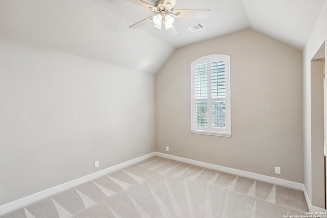 additional living space with light carpet, vaulted ceiling, and ceiling fan