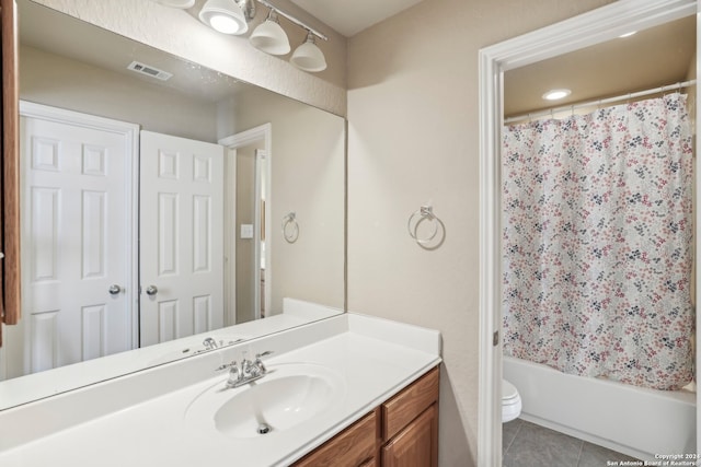 full bathroom featuring tile patterned floors, vanity, toilet, and shower / bath combo