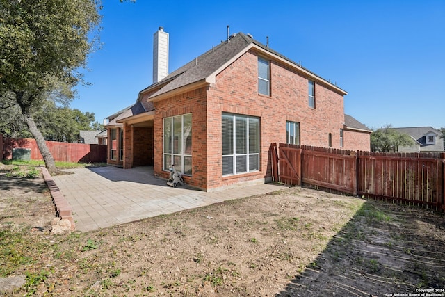 rear view of property with a patio area