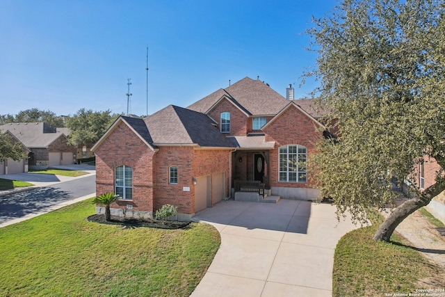 front facade with a front lawn and a garage