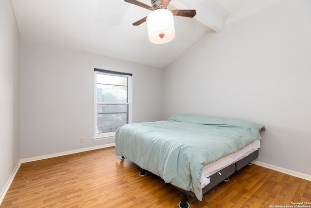 bedroom with vaulted ceiling with beams, ceiling fan, and hardwood / wood-style flooring