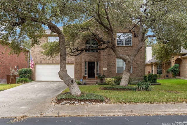 view of front of home with a garage and a front lawn