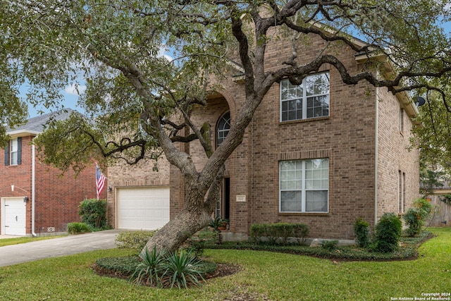 view of front facade featuring a front yard and a garage