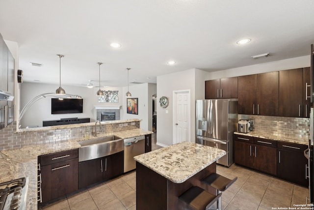 822 Emerald Bay, San Antonio, TX 78260 - kitchen with appliances with stainless steel finishes, decorative backsplash, ceiling fan, dark brown cabinets, and recessed lighting