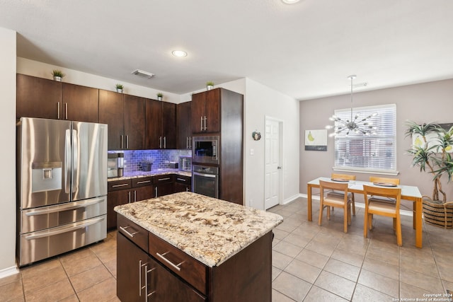 kitchen with tasteful backsplash, a chandelier, decorative light fixtures, dark brown cabinets, and appliances with stainless steel finishes