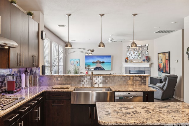 kitchen featuring hanging light fixtures, ceiling fan, decorative backsplash, appliances with stainless steel finishes, and dark brown cabinets