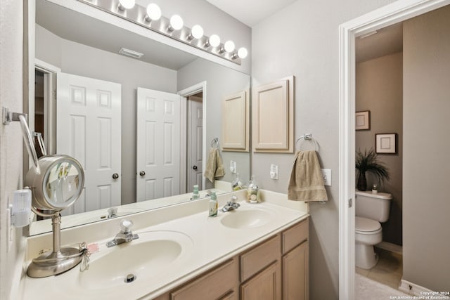 bathroom with tile patterned floors, vanity, and toilet