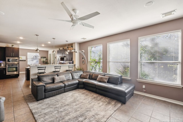 tiled living room featuring ceiling fan