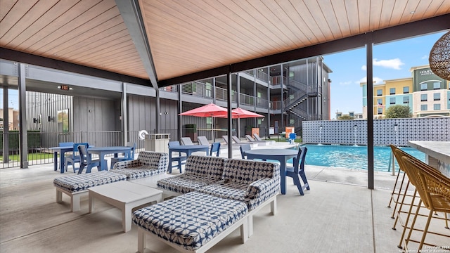 view of patio featuring pool water feature and a community pool