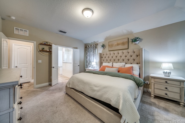 carpeted bedroom with a textured ceiling and vaulted ceiling