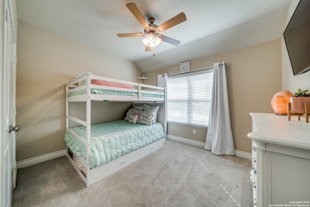 bedroom featuring ceiling fan, light carpet, and vaulted ceiling