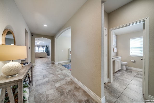 hallway with lofted ceiling