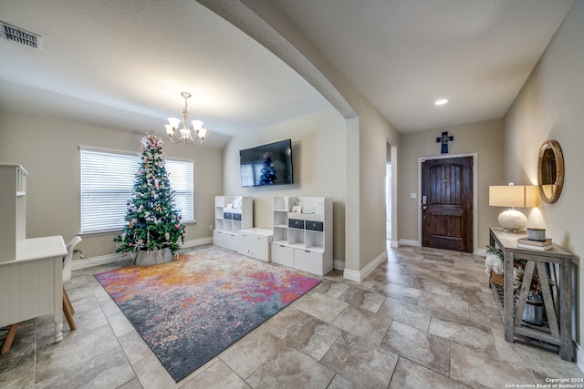 entryway with a notable chandelier