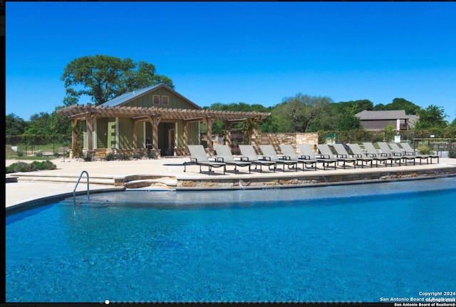 view of pool with a pergola and a patio