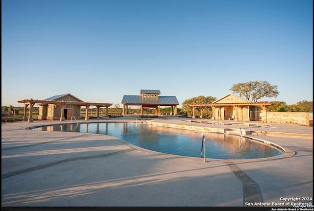 view of swimming pool with a patio area