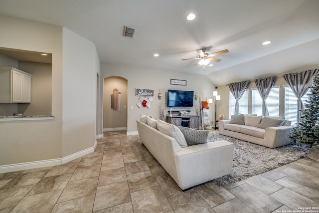 living room featuring ceiling fan and lofted ceiling