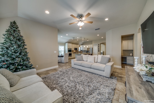 living room featuring vaulted ceiling and ceiling fan