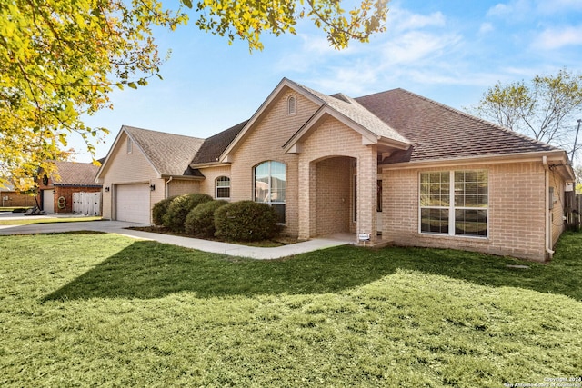 view of front of property with a garage and a front lawn