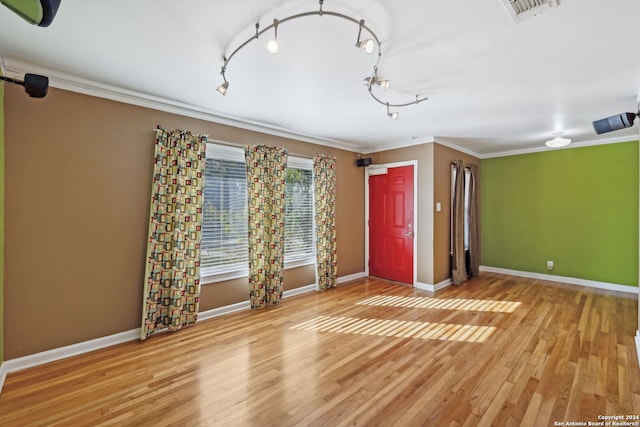 entrance foyer with crown molding and light wood-type flooring