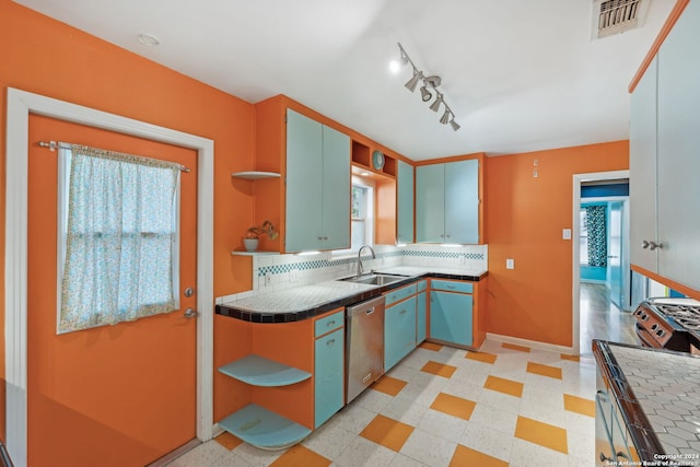 kitchen featuring stainless steel dishwasher, a wealth of natural light, and tile countertops