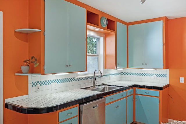 kitchen featuring dishwasher, tasteful backsplash, tile counters, and sink